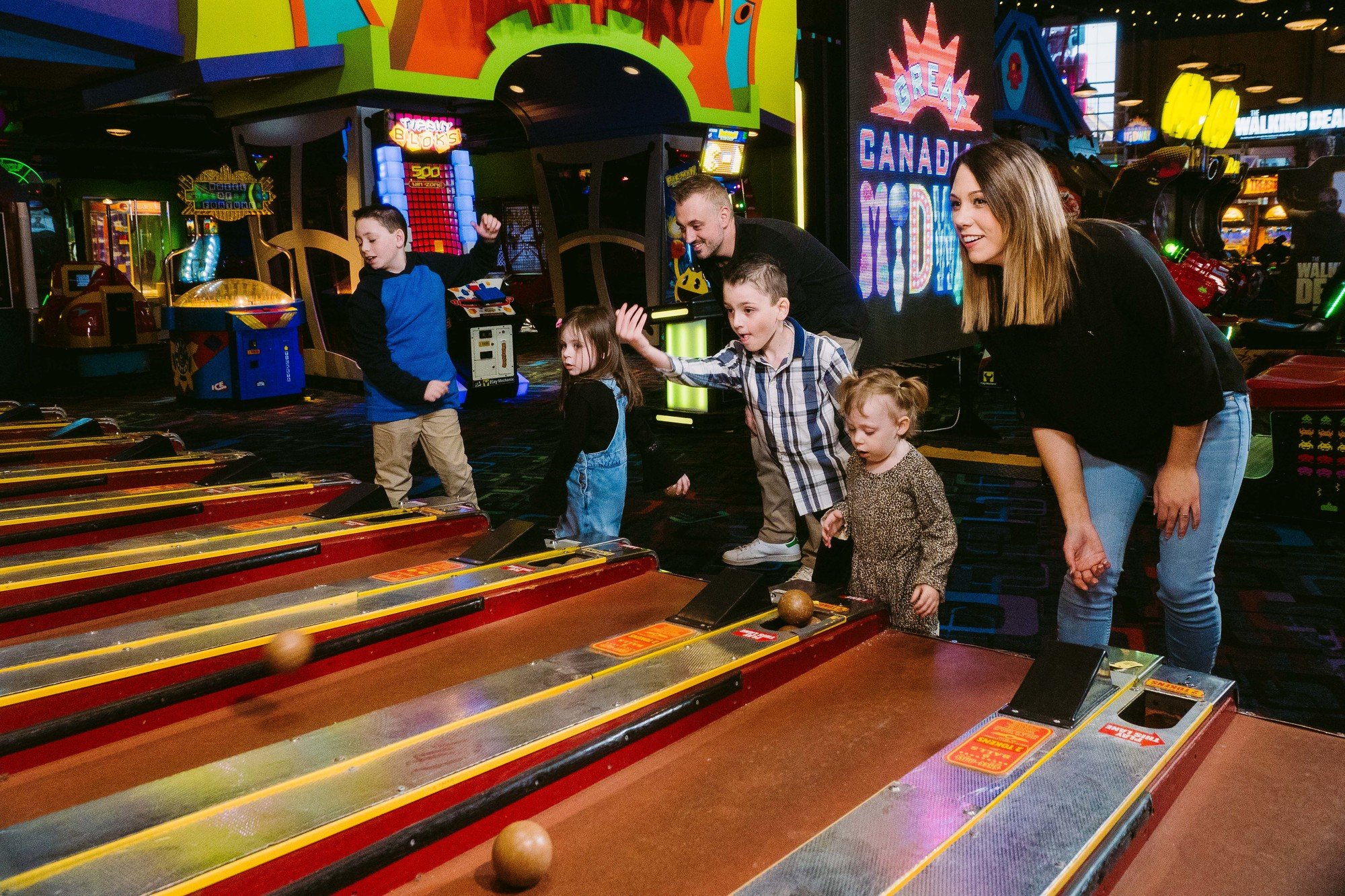 Skeet ball family having a game together