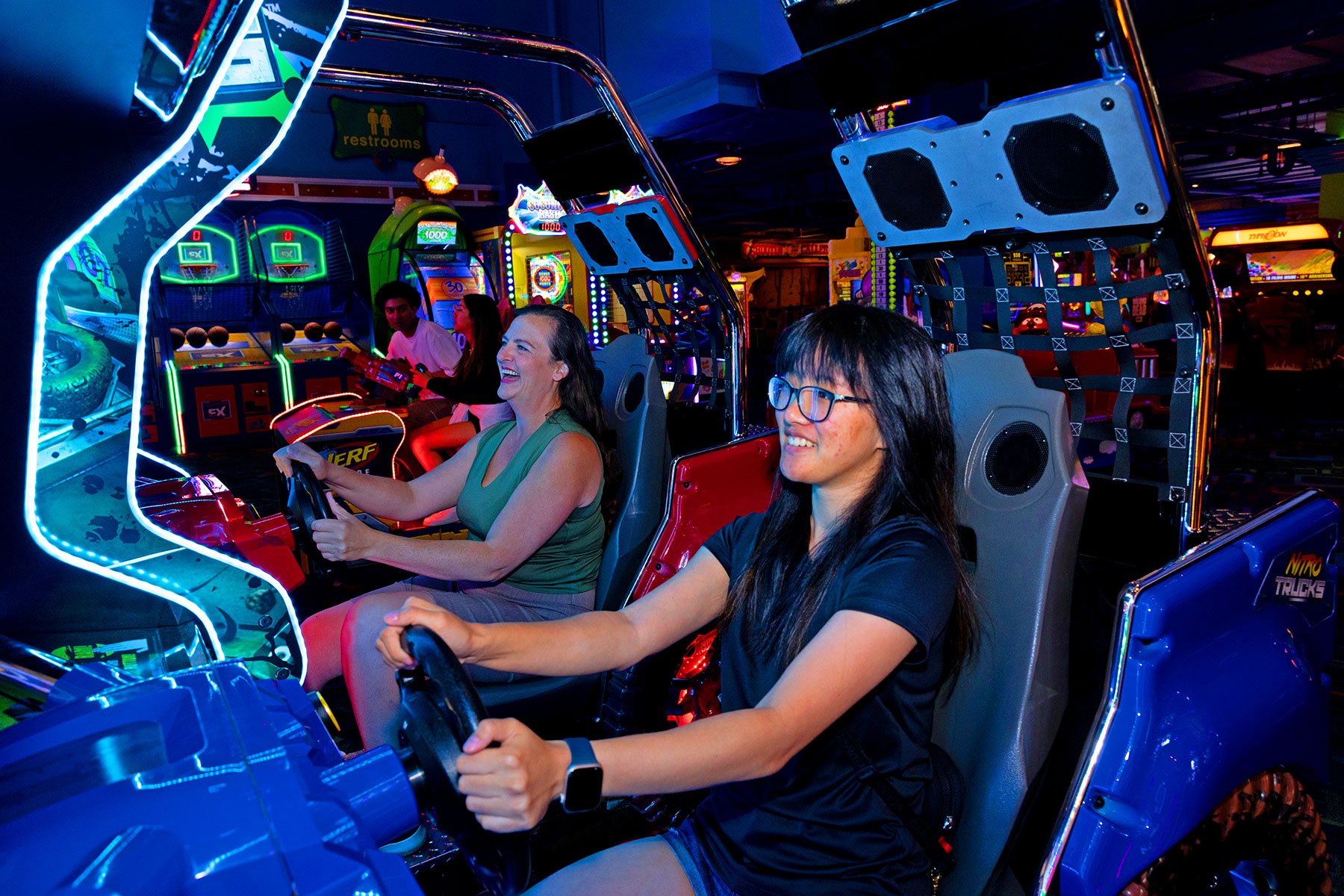 Daughter and mom pair up for battle with driving arcade game