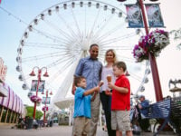 Family enjoying ice cream On Clifton Hill in front of SkyWheel