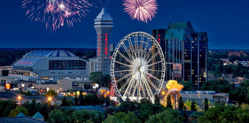 Aerial photo of Casino NIagara's Exterior with SkyWheel in foreground at night